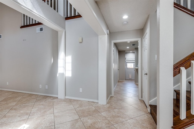 entryway with light tile patterned flooring