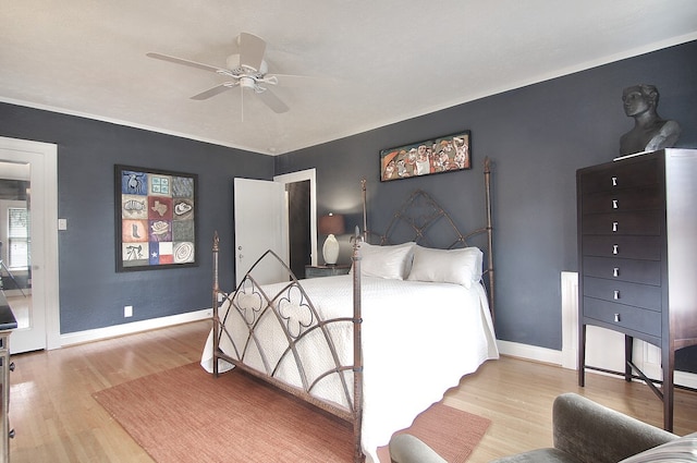 bedroom with crown molding, ceiling fan, and light hardwood / wood-style flooring