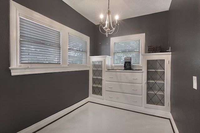 dining area with a chandelier and concrete floors