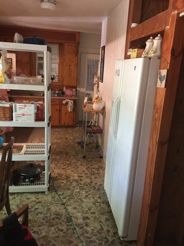 interior space with white refrigerator with ice dispenser