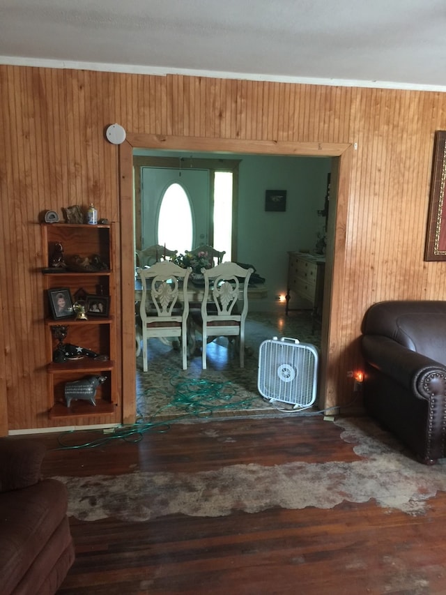 living room with wood-type flooring and wooden walls