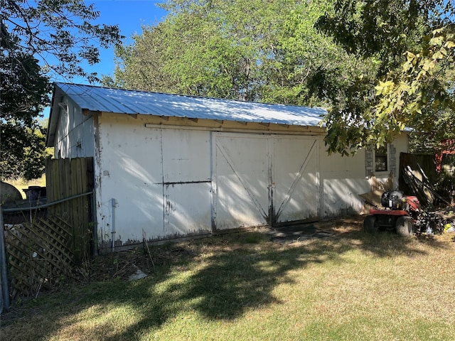 view of outdoor structure with a lawn