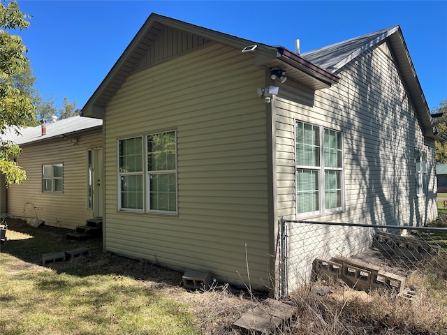 view of side of home with a lawn