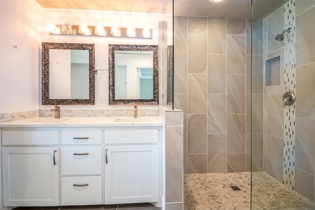 bathroom featuring tiled shower and vanity