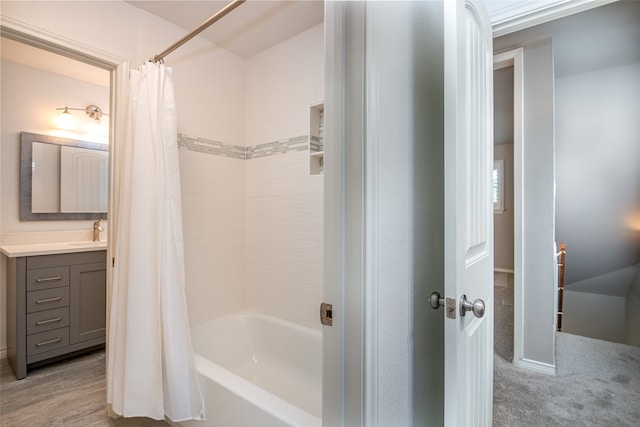 bathroom featuring shower / tub combo with curtain, hardwood / wood-style floors, and vanity