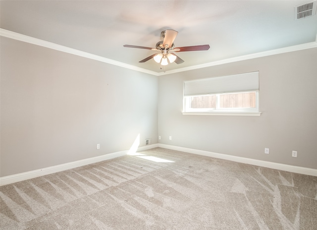 carpeted spare room featuring crown molding and ceiling fan