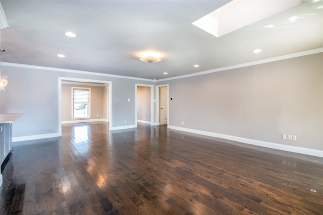 unfurnished living room featuring ornamental molding, a skylight, and dark hardwood / wood-style flooring