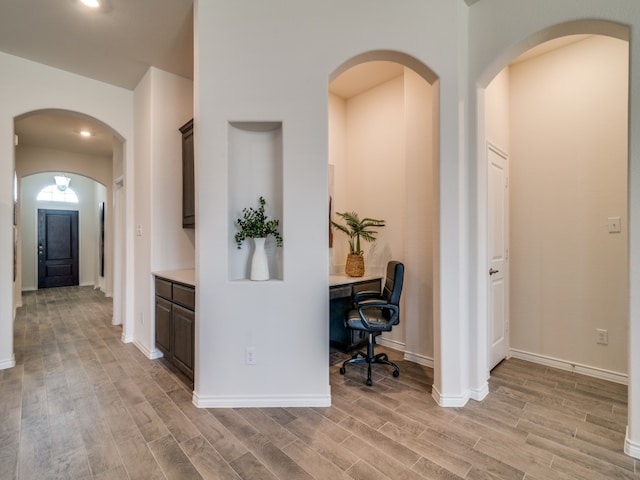 hallway with light hardwood / wood-style flooring