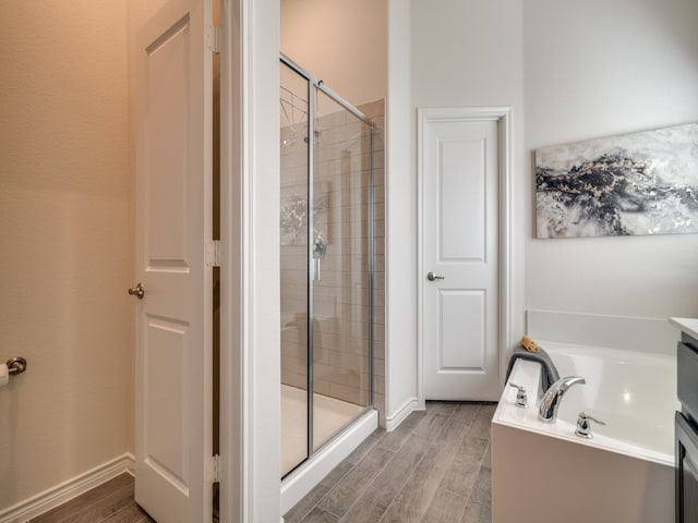 bathroom with vanity, wood-type flooring, and independent shower and bath