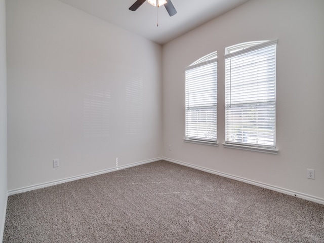 spare room featuring ceiling fan and carpet