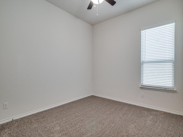 carpeted empty room with baseboards and ceiling fan