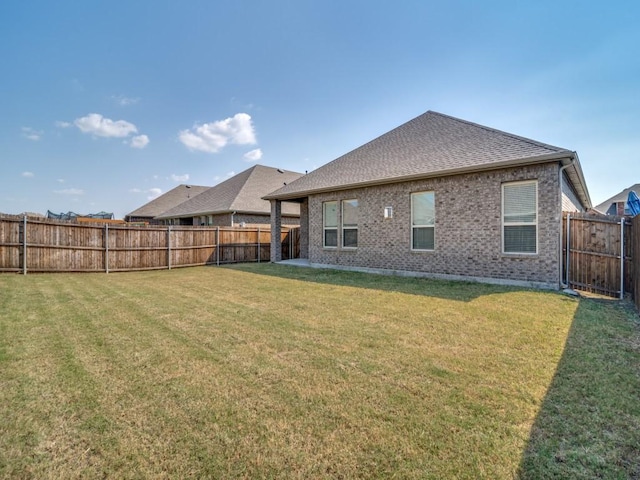 rear view of property featuring a yard