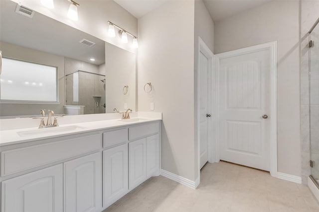 bathroom featuring vanity and an enclosed shower