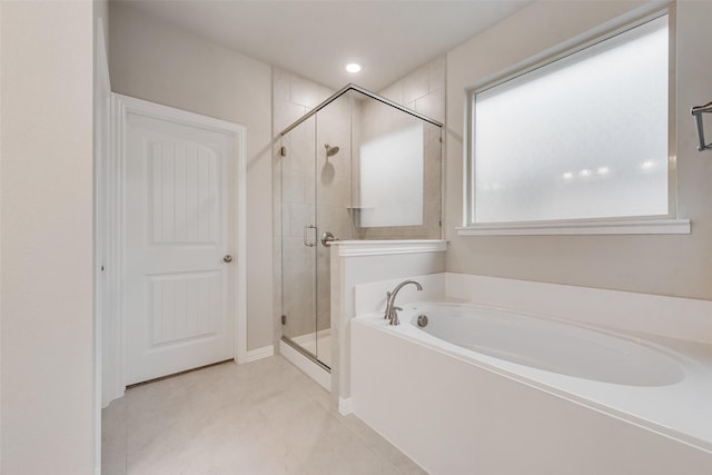 bathroom featuring tile patterned floors and separate shower and tub