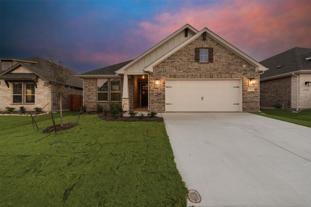 view of front of property with a front lawn and a garage