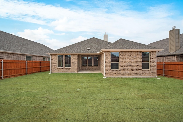 back of house with a yard and a patio area