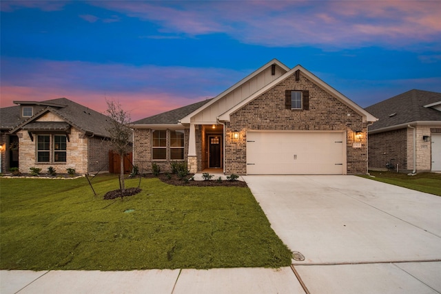 view of front facade with a garage and a lawn