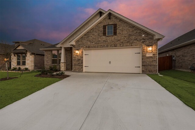 craftsman-style home with a lawn and a garage