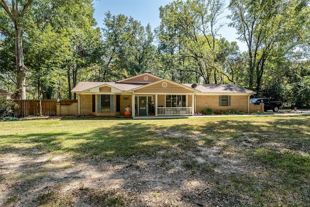 single story home with a porch and a front lawn