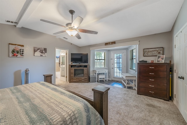 bedroom with ceiling fan, ensuite bath, vaulted ceiling with beams, and carpet floors