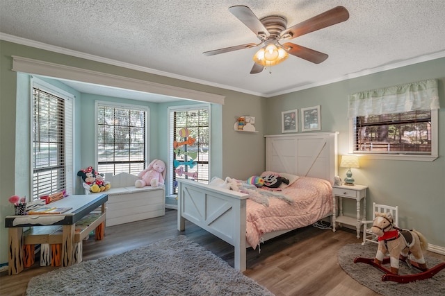 bedroom featuring crown molding, hardwood / wood-style floors, a textured ceiling, and ceiling fan