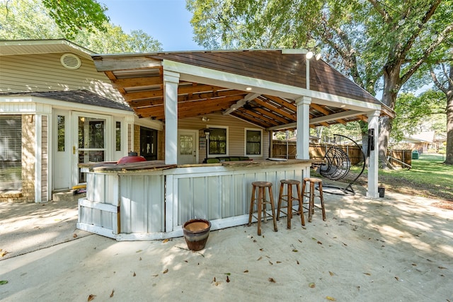 view of patio with an outdoor bar