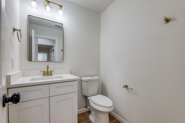 bathroom featuring hardwood / wood-style flooring, vanity, and toilet