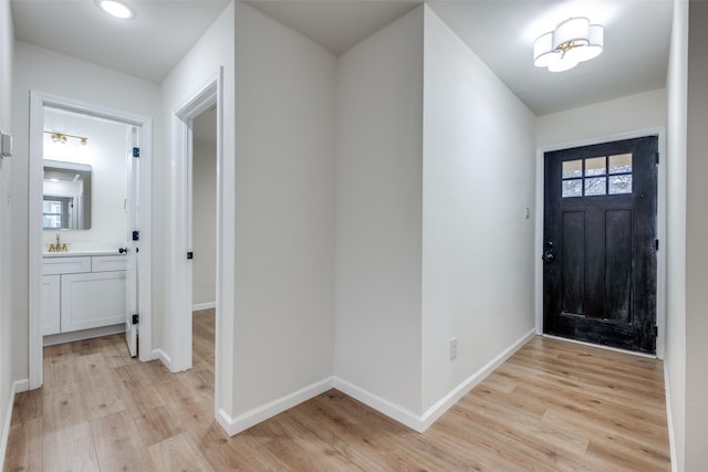 entryway featuring light hardwood / wood-style floors and sink