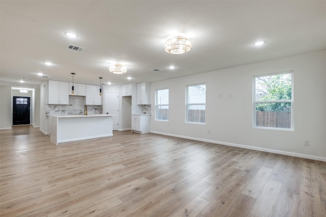 unfurnished living room featuring light hardwood / wood-style flooring