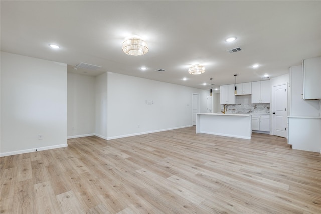 unfurnished living room with light wood-type flooring