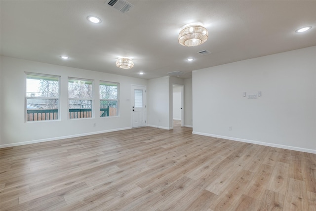 empty room with light hardwood / wood-style floors