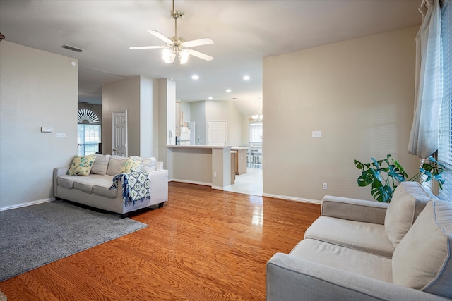 living room featuring light hardwood / wood-style floors and ceiling fan