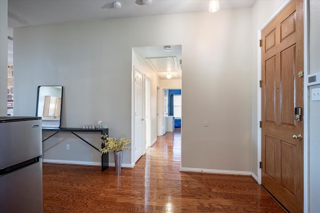 corridor with dark hardwood / wood-style flooring