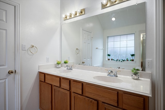 bathroom with vanity and vaulted ceiling