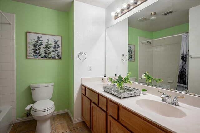 7906 Munich Dr, Rowlett, TX 75089 - bathroom with toilet, double vanity, baseboards, and shower / bath combo with shower curtain