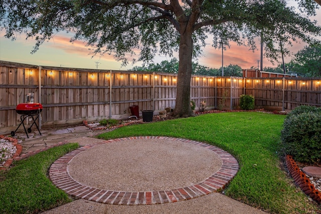 yard at dusk with a patio area