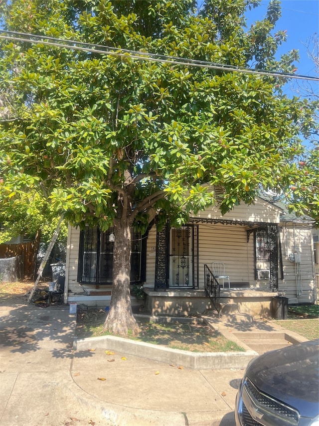 obstructed view of property with a porch