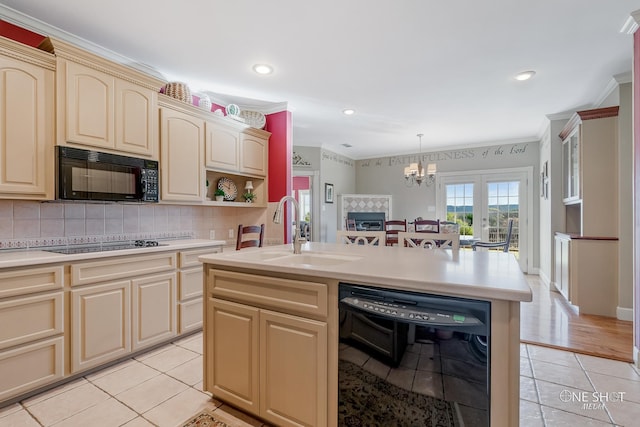 kitchen with french doors, sink, an island with sink, light tile patterned floors, and black appliances