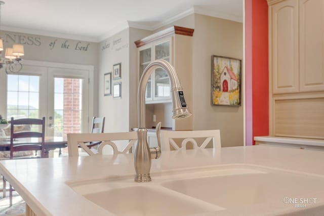 interior space with french doors, crown molding, and sink