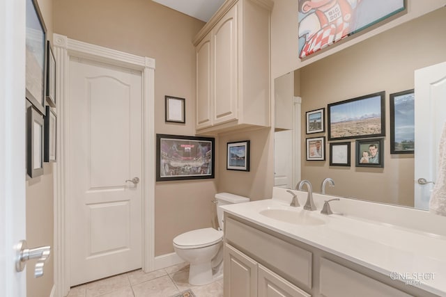 bathroom featuring tile patterned flooring, vanity, and toilet