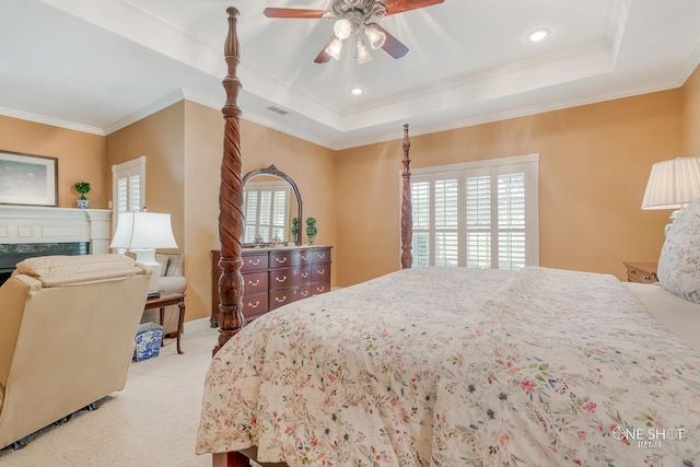 bedroom with ceiling fan, light colored carpet, crown molding, and multiple windows