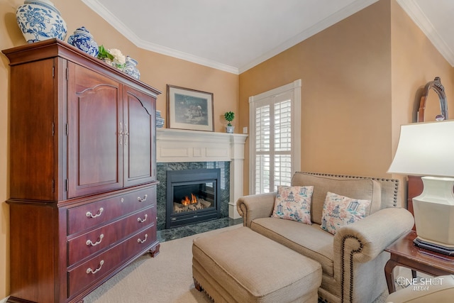 sitting room with light carpet, ornamental molding, and a high end fireplace