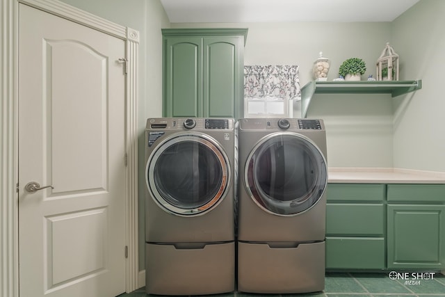 washroom with dark tile patterned flooring, cabinets, and independent washer and dryer