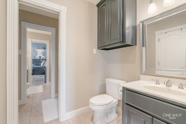 bathroom featuring tile patterned flooring, vanity, and toilet