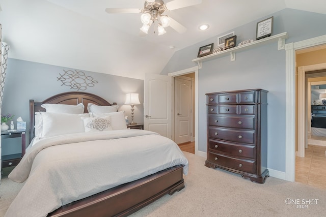 carpeted bedroom with ceiling fan and vaulted ceiling