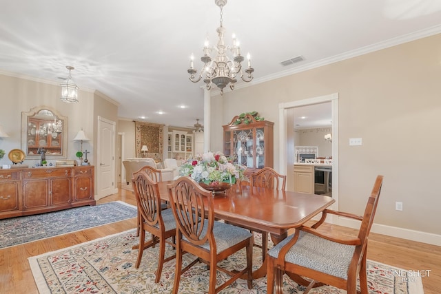 dining room with beverage cooler, an inviting chandelier, ornamental molding, and light wood-type flooring