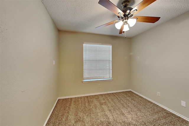 carpeted empty room featuring ceiling fan and a textured ceiling