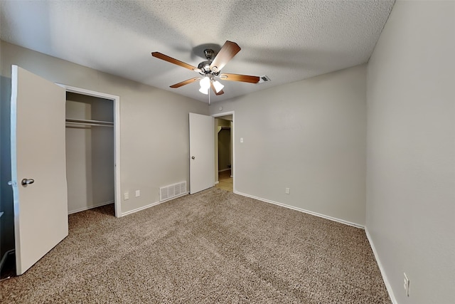 unfurnished bedroom featuring ceiling fan, a closet, carpet, and a textured ceiling