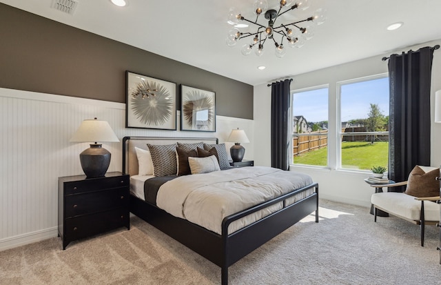 carpeted bedroom with a chandelier