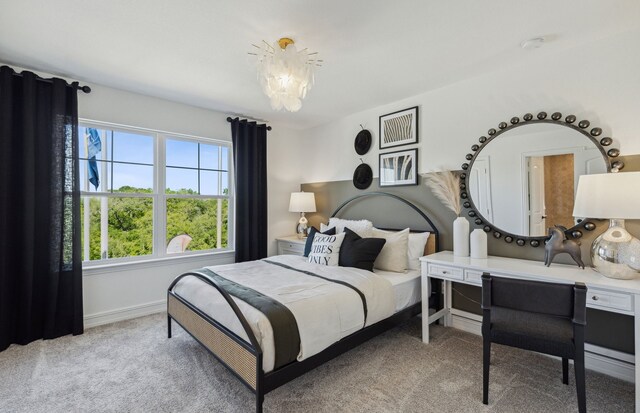 carpeted bedroom with a notable chandelier